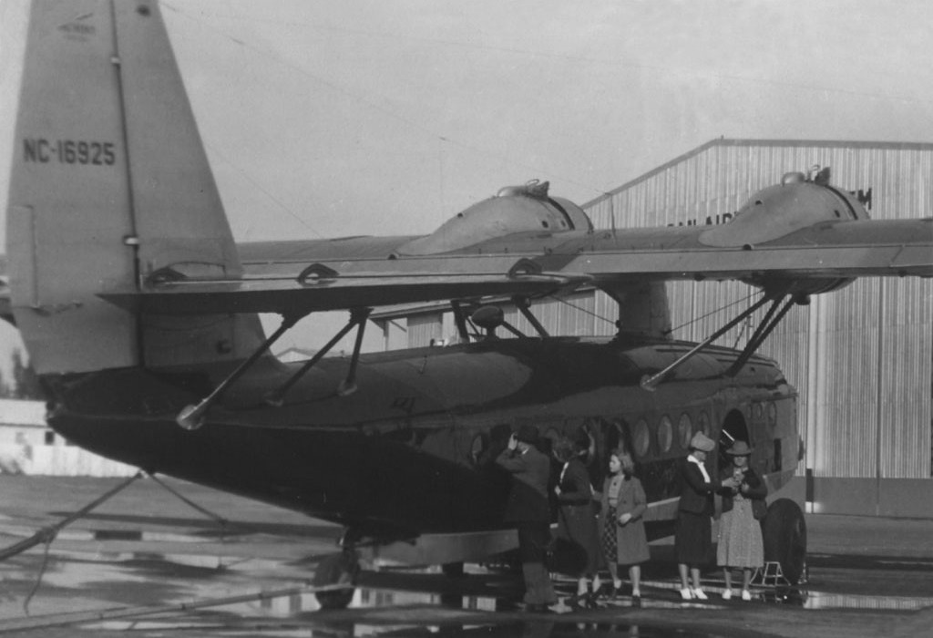 1930s Pan Am Sikorsky S43 flying boat tail number  NC16925 with passengers by the aircraft.
